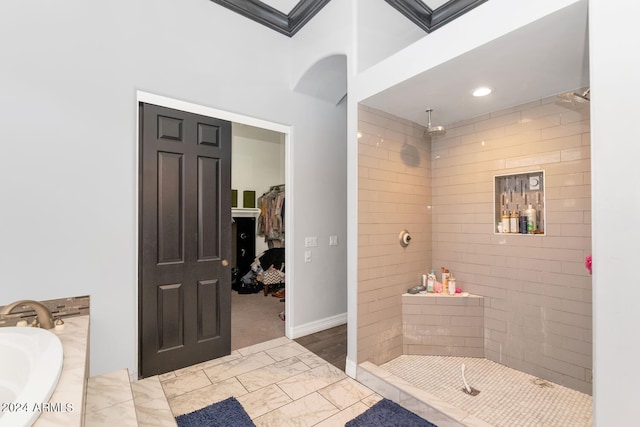 bathroom featuring tile patterned flooring and shower with separate bathtub