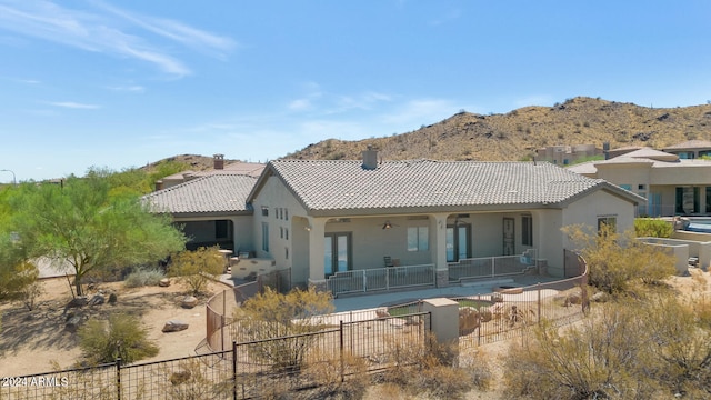 back of house with a mountain view, a fenced in pool, and a patio area