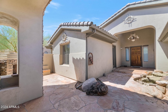 entrance to property featuring a patio area