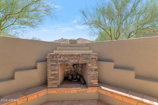 exterior details featuring an outdoor stone fireplace