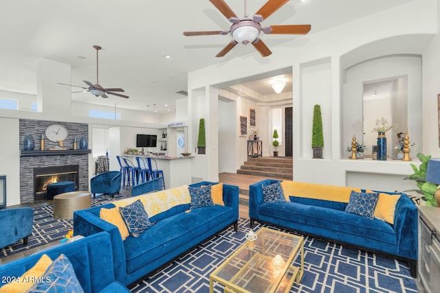 living room with hardwood / wood-style flooring, a fireplace, and ceiling fan