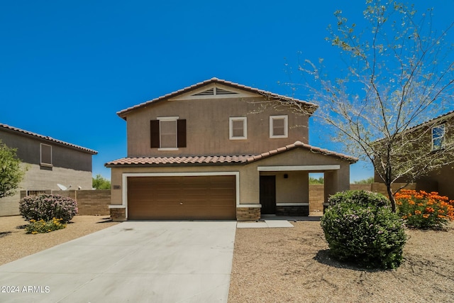 mediterranean / spanish-style house with a garage