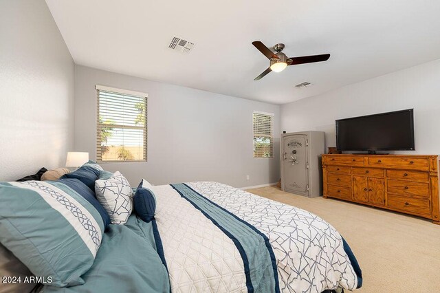 carpeted bedroom with multiple windows and ceiling fan