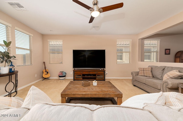 carpeted living room with a healthy amount of sunlight and ceiling fan