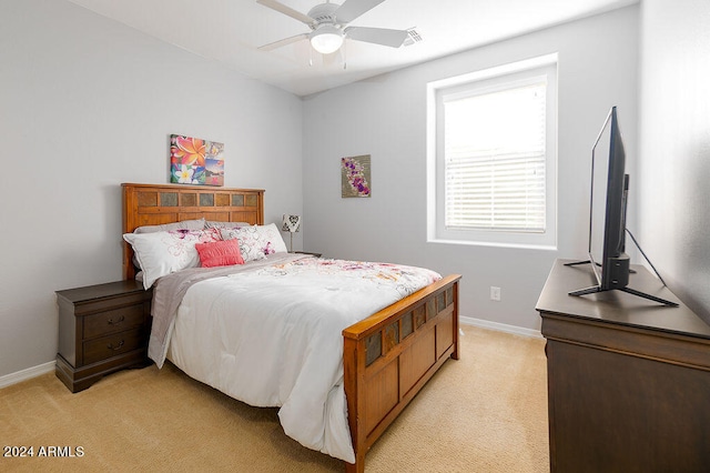 bedroom with light colored carpet and ceiling fan