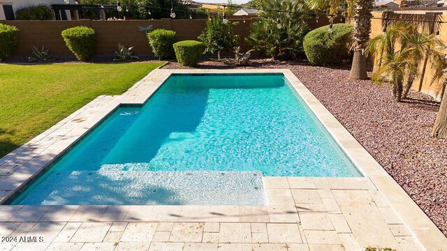 view of pool featuring a yard