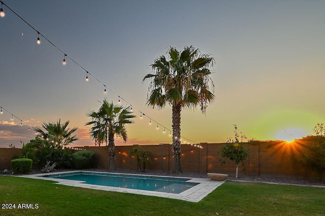 pool at dusk with a yard