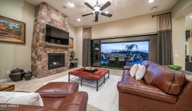 living area featuring recessed lighting, a fireplace, visible vents, baseboards, and a ceiling fan