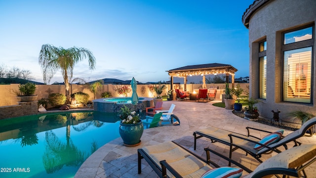 view of swimming pool with a patio, a pool with connected hot tub, a gazebo, a mountain view, and a fenced backyard