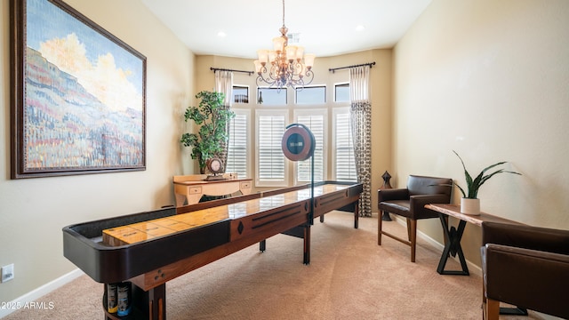 office area with an inviting chandelier, visible vents, baseboards, and light colored carpet