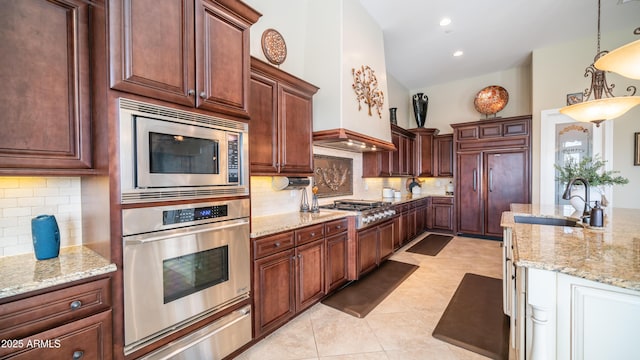 kitchen with built in appliances, light tile patterned floors, a sink, light stone countertops, and a warming drawer