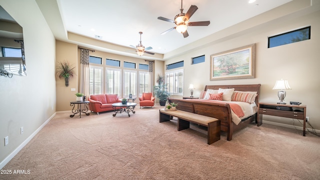 carpeted bedroom featuring recessed lighting, a raised ceiling, visible vents, and baseboards