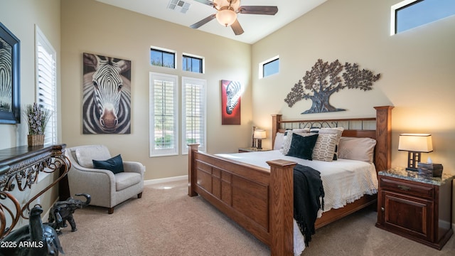 bedroom with light carpet, a ceiling fan, visible vents, and baseboards