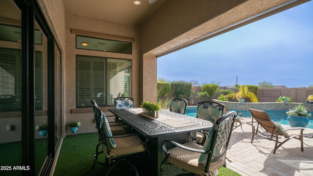 view of patio / terrace with a fenced backyard, a fenced in pool, and outdoor dining space