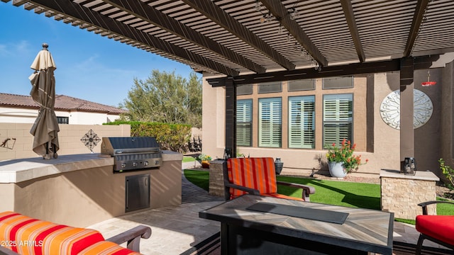 view of patio with exterior kitchen, a pergola, a grill, and fence