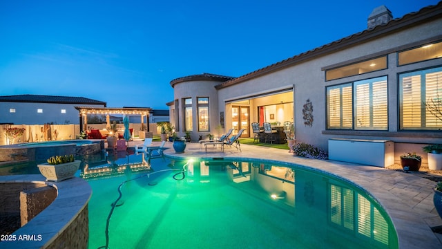 view of swimming pool featuring an in ground hot tub, a patio, fence, and a fenced in pool