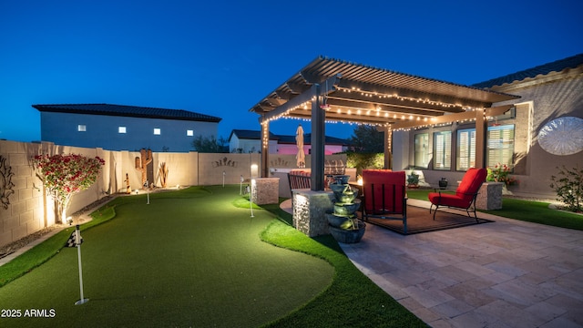 patio at twilight with a fenced backyard and a pergola