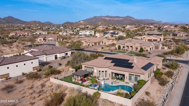 birds eye view of property with a mountain view and a residential view