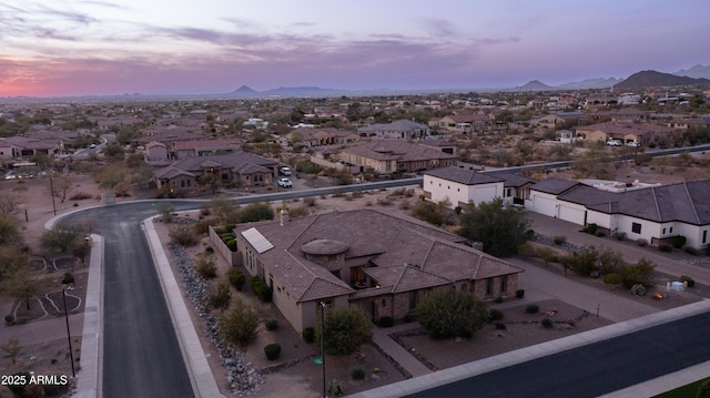 aerial view at dusk with a mountain view and a residential view