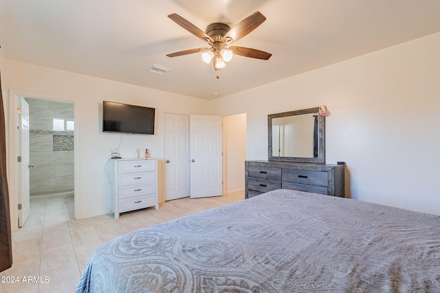 bedroom featuring connected bathroom, ceiling fan, and light tile patterned flooring