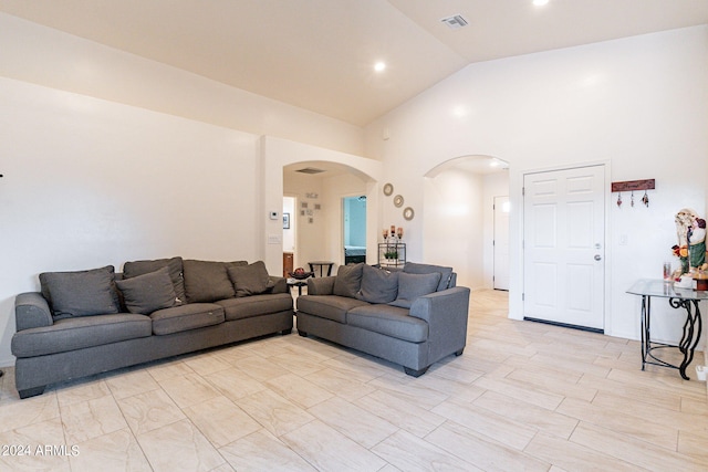 living room with high vaulted ceiling