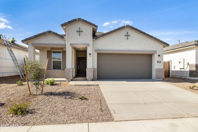 17848 W Mission Ln, Waddell, AZ 85355 - view of front of home with a garage, driveway, stucco siding, and a tiled roof