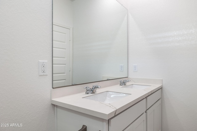 17848 W Mission Ln, Waddell, AZ 85355 - bathroom with double vanity and a textured wall
