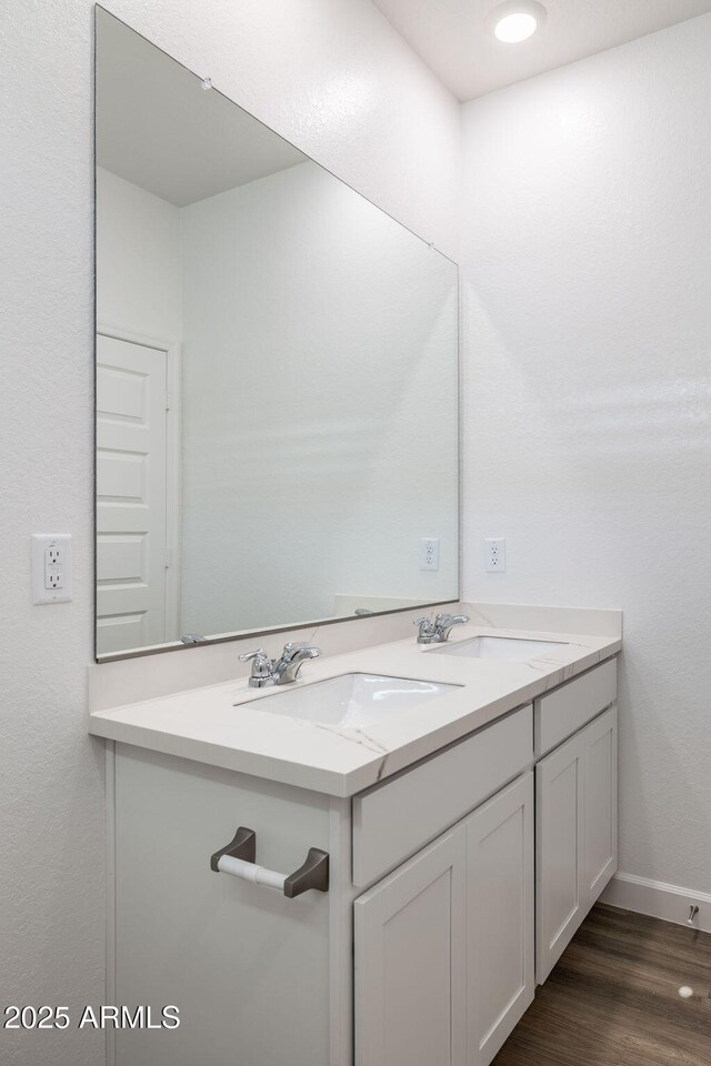 17848 W Mission Ln, Waddell, AZ 85355 - bathroom with wood finished floors, baseboards, and double vanity