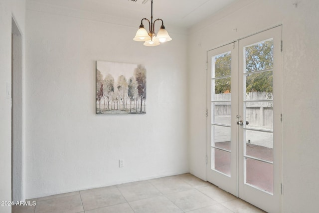 unfurnished dining area featuring french doors, crown molding, light tile patterned floors, and an inviting chandelier