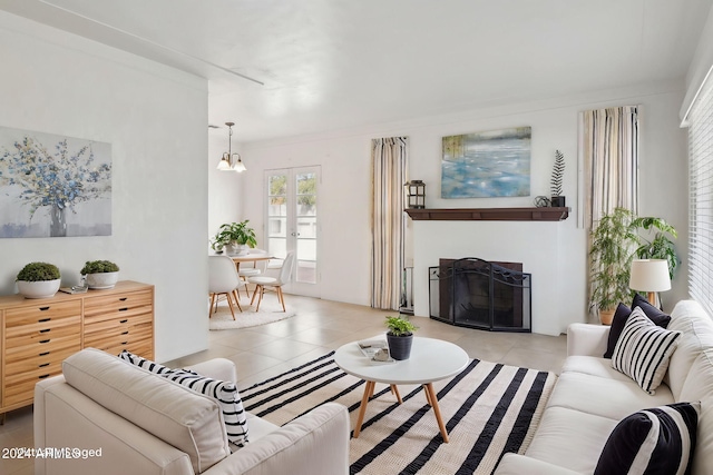 tiled living room with french doors and a chandelier