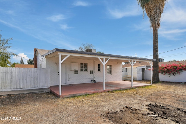 rear view of property with a patio and central air condition unit