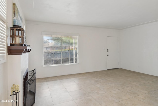 tiled spare room with ornamental molding