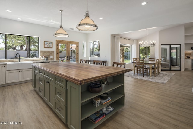 kitchen with light wood finished floors, butcher block countertops, french doors, open shelves, and recessed lighting