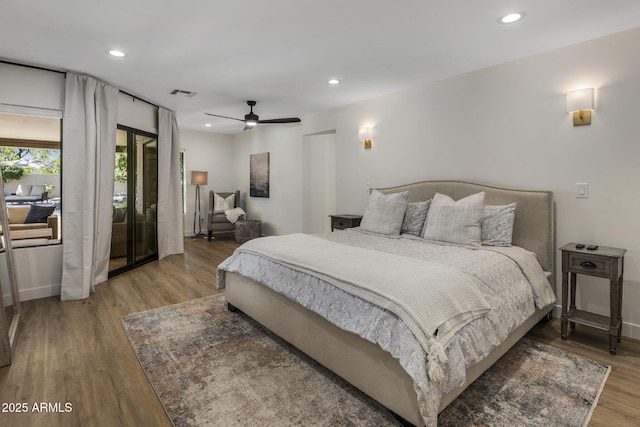 bedroom with a ceiling fan, visible vents, wood finished floors, and recessed lighting