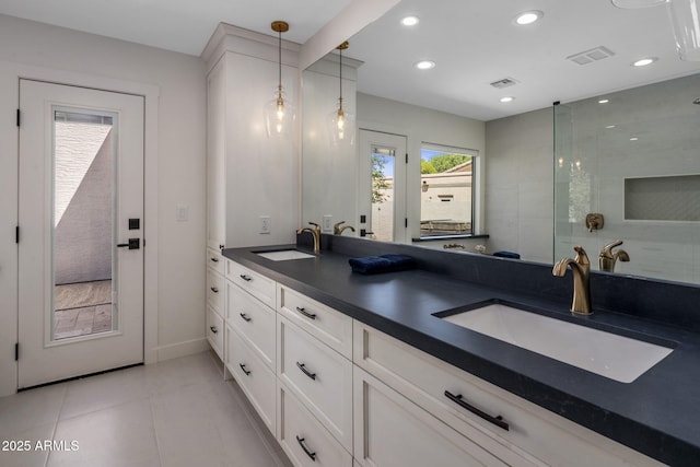 full bathroom with double vanity, a sink, visible vents, and recessed lighting