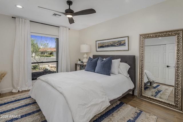 bedroom featuring baseboards, visible vents, ceiling fan, wood finished floors, and recessed lighting