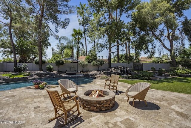 view of patio featuring an outdoor fire pit, a fenced in pool, and a fenced backyard