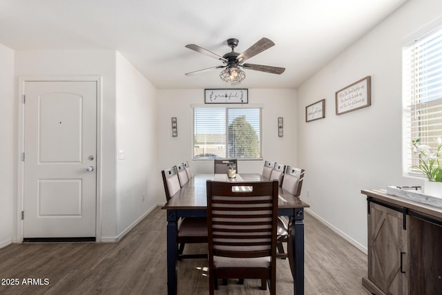 dining room with ceiling fan and dark hardwood / wood-style floors