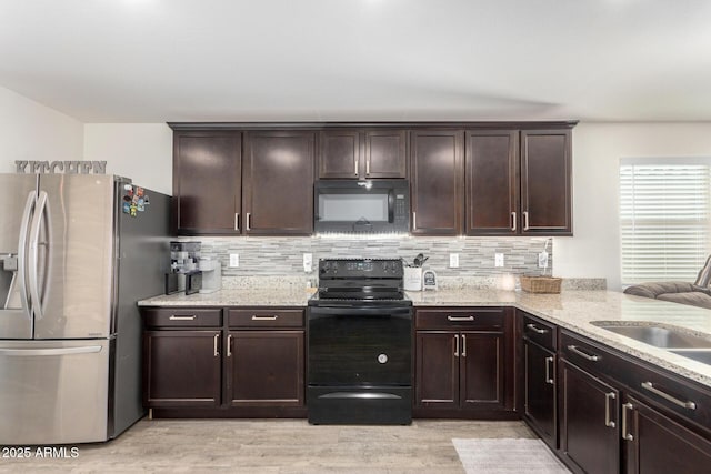 kitchen featuring sink, dark brown cabinets, black appliances, and decorative backsplash