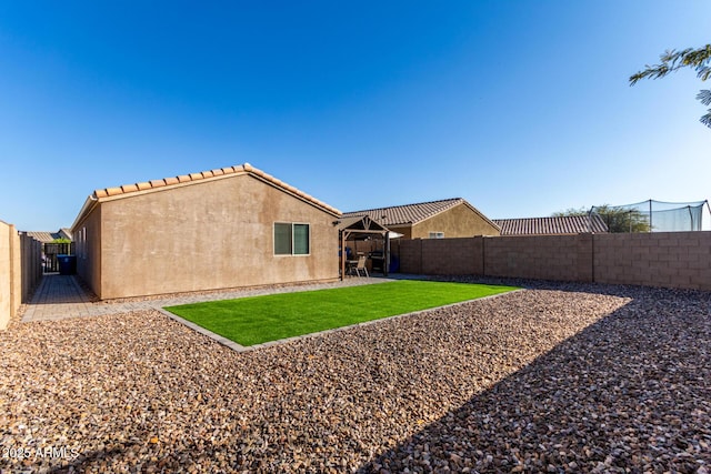 rear view of property with a lawn and a patio