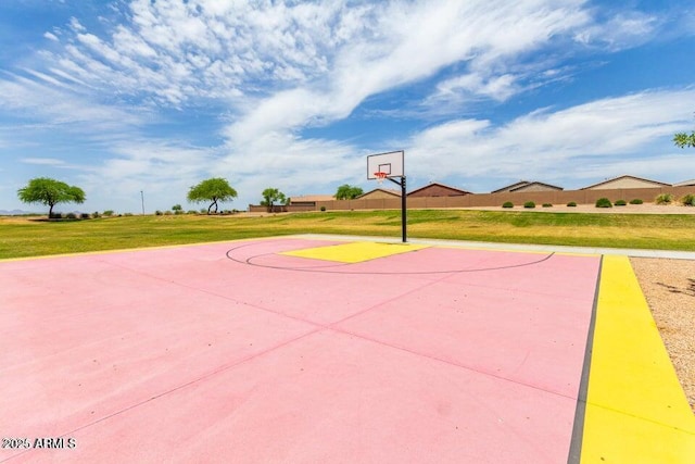 view of sport court with a yard