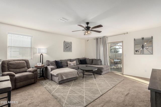 carpeted living room featuring ceiling fan