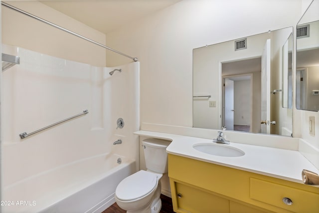 full bathroom featuring shower / bath combination, vanity with extensive cabinet space, and toilet