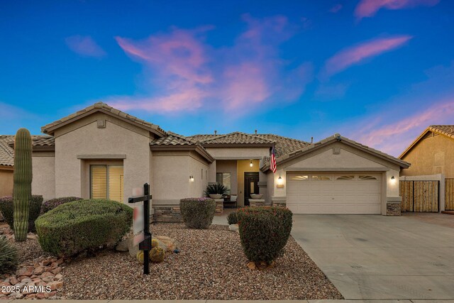 25454 N 73rd Ave, Peoria, AZ 85383 - view of front of house featuring driveway, stucco siding, a tile roof, and a garage