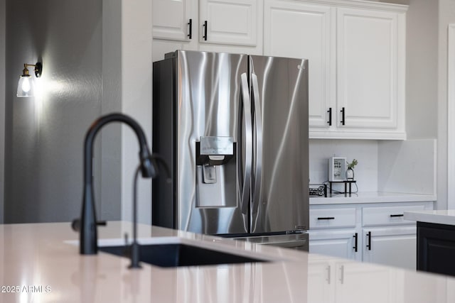 25454 N 73rd Ave, Peoria, AZ 85383 - interior details with stainless steel fridge with ice dispenser, light countertops, and white cabinets