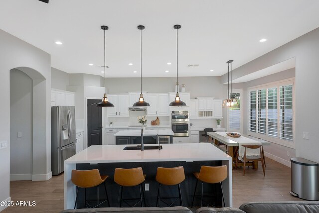25454 N 73rd Ave, Peoria, AZ 85383 - kitchen with a sink, a large island with sink, wood finished floors, and appliances with stainless steel finishes