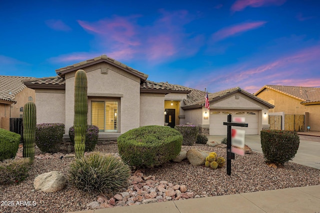 25454 N 73rd Ave, Peoria, AZ 85383 - mediterranean / spanish-style home with fence, a garage, concrete driveway, a tile roof, and stucco siding