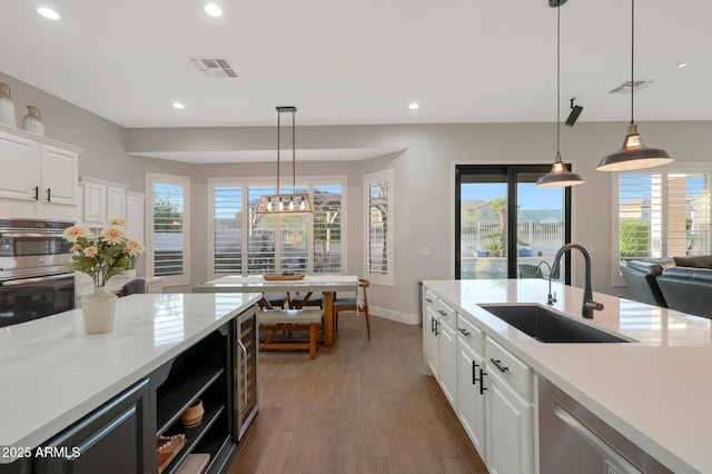 25454 N 73rd Ave, Peoria, AZ 85383 - kitchen with appliances with stainless steel finishes, visible vents, light countertops, and a sink