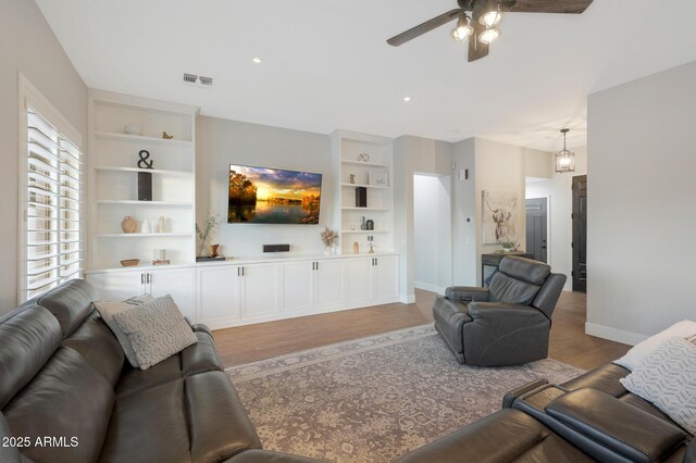 25454 N 73rd Ave, Peoria, AZ 85383 - living area featuring light wood-style flooring, baseboards, visible vents, a ceiling fan, and built in features
