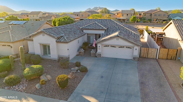 25454 N 73rd Ave, Peoria, AZ 85383 - view of front of home featuring stucco siding, fence, a residential view, driveway, and a garage